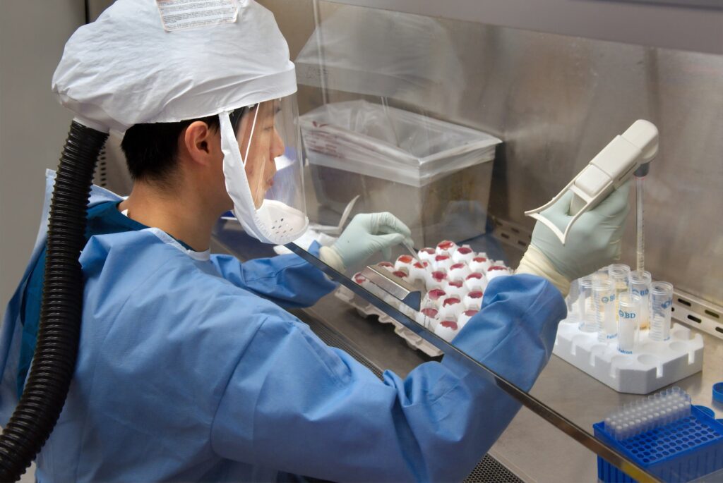 A lab technician running tests on multiple vials of samples