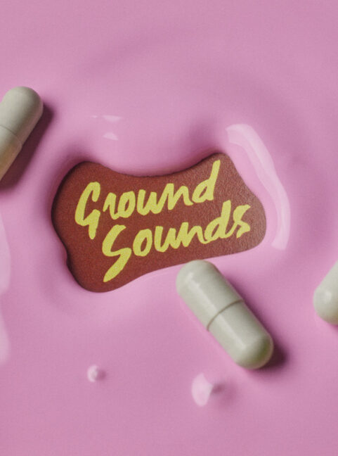 Ground sounds logo on a brown background in the centre of pink liquid with pills in the liquid